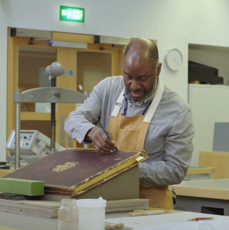 Book conservator treating item