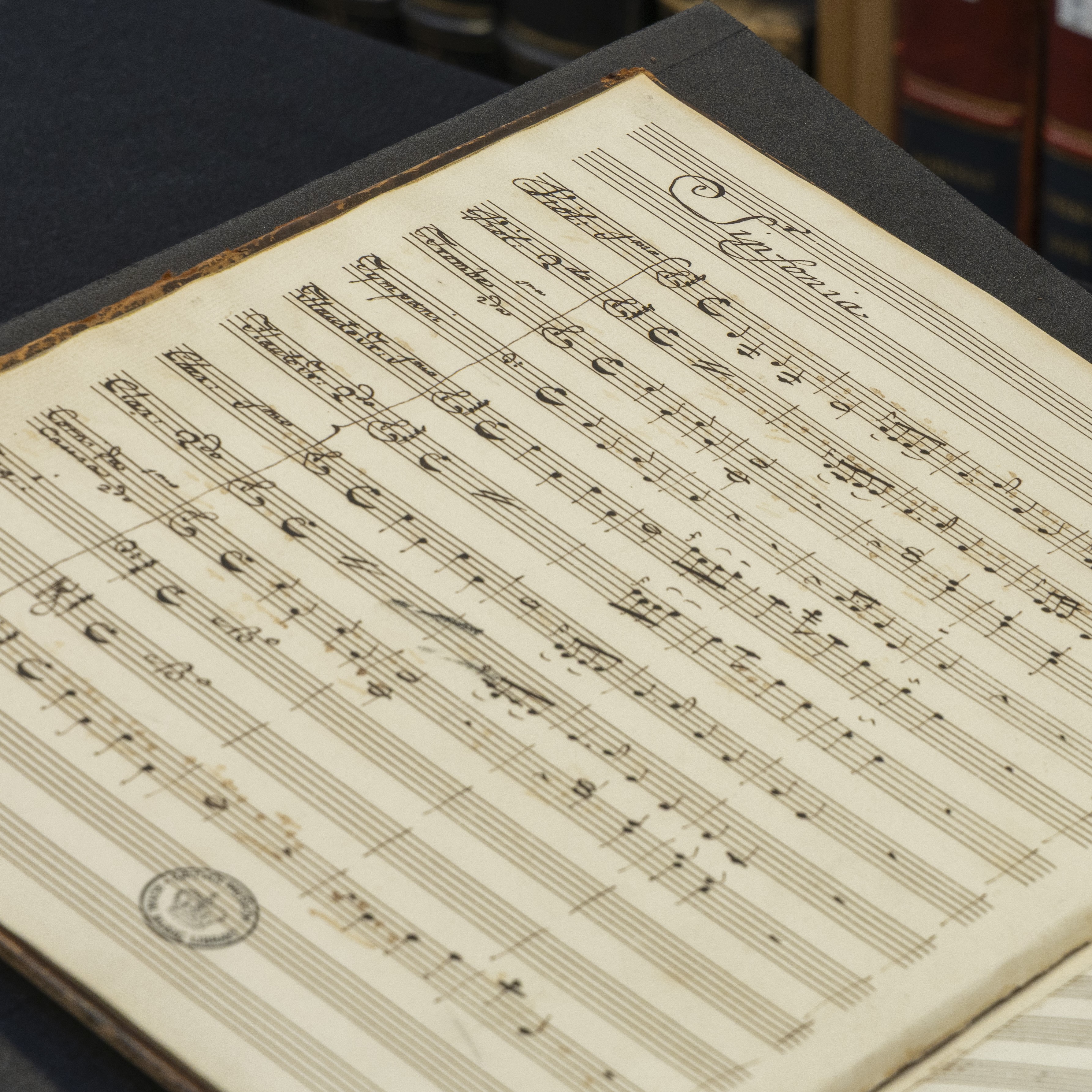 Handwritten music scores with the title 'Sinfonia' written in beautiful script 